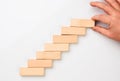 Man hand put wooden blocks in the shape of a staircase Royalty Free Stock Photo