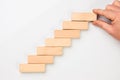 Man hand put wooden blocks in the shape of a staircase Royalty Free Stock Photo