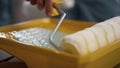 Man hand putting paint roller to tray in new apartment. Diy improvement concept. Royalty Free Stock Photo