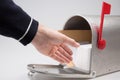 Man hand putting parcel and mail in delivering postmail mailbox Royalty Free Stock Photo