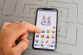 Man hand selecting sad rabbit animoji emoji