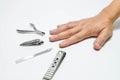 Man hand with set of manicure and pedicure tools and accessories on white background. Royalty Free Stock Photo