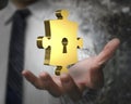 Man hand showing golden puzzle piece with keyhole Royalty Free Stock Photo