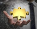 Man hand showing golden puzzle piece Royalty Free Stock Photo