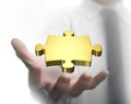 Man hand showing golden puzzle piece Royalty Free Stock Photo