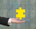 Man hand showing one 3D gold jigsaw puzzle piece Royalty Free Stock Photo