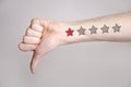 Man hand showing thumbs down and one star rating Royalty Free Stock Photo