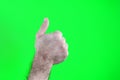 man hand shows thumbs up, isolated on green Happy man giving thumbs up sign full length portrait on white background