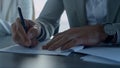 Man hand signing papers in office closeup. Insurance client checking agreement Royalty Free Stock Photo