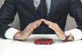 Man hand small red car on table