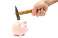 Man hand smashes a pink piggy Bank on a white background with a hammer Royalty Free Stock Photo