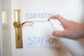 Man hand spraying alcohol sanitizer bottle to the door handle, against Novel coronavirus or Corona Virus Disease Covid-19 at. Hygi Royalty Free Stock Photo