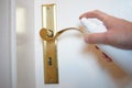 Man hand spraying alcohol sanitizer bottle to the door handle, against Novel coronavirus or Corona Virus Disease Covid-19 at. Hygi Royalty Free Stock Photo