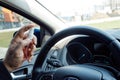 Man hand spraying alcohol sanitizer on steering wheel in his car, Corona Virus Disease Covid 19. Antiseptic, Hygiene and Royalty Free Stock Photo
