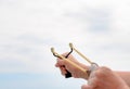 Man Hand Stretching Bands of his Stone Shooter