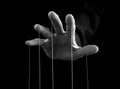 Man hand with strings on fingers. Manipulation, power concept. Male making person feel fear, obligation, guilt. Black Royalty Free Stock Photo