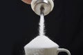 Man hand with sugar bowl pouring a crazy lot in full coffee cup in addiction concept Royalty Free Stock Photo