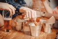 Man hand takes snacks crackers, croutons with sauce and drinks beer in pub bar at wooden table