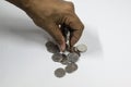 A man hand taking UAE currency coins with white background, fils