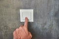 Man hand, to turn off the light, switch, front view Royalty Free Stock Photo