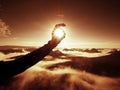 Man hand touch Sun. Misty daybreak in a beautiful hills. Royalty Free Stock Photo