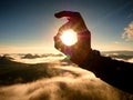 Man hand touch Sun. Misty daybreak in a beautiful hills. Royalty Free Stock Photo