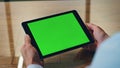 Man hand touching green tablet screen indoor closeup. Manager using computer Royalty Free Stock Photo