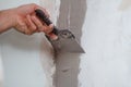 man hand with trowel plastering a wall, skim coating plaster walls. Royalty Free Stock Photo