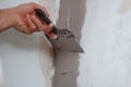 man hand with trowel plastering a wall, skim coating plaster walls. Royalty Free Stock Photo