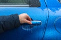 Man hand trying to open freezing car door handle, Hand on Car`s door handle after a freezing rain Royalty Free Stock Photo