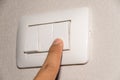 Man hand is turning on or off electrical light switch Royalty Free Stock Photo