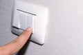 Man hand is turning on or off electrical light switch Royalty Free Stock Photo