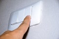 Man hand is turning on or off electrical light switch Royalty Free Stock Photo