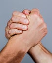 Man hand. Two men arm wrestling. Arms wrestling. Closep up. Friendly handshake, friends greeting, teamwork, friendship Royalty Free Stock Photo