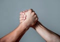 Man hand. Two men arm wrestling. Arms wrestling. Closep up. Friendly handshake, friends greeting, teamwork, friendship Royalty Free Stock Photo