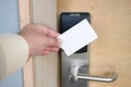 Man hand use key card switch in to open hotel room door Royalty Free Stock Photo