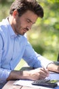 man hand using calculator outdoors