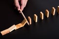 man hand using a pen stop domino falling effect on black background ,using idea to solve the problem Royalty Free Stock Photo