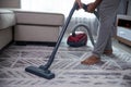 Man hand vacuuming carpet