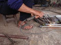 close up, man welding broken chair at his workshop