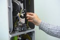 Man hand working with a gas condensing boiler disassembled, parts of section gas condenser Royalty Free Stock Photo