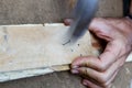 Man hand working on wood with a hammer Royalty Free Stock Photo