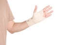 Man with hand wrapped in medical bandage on white background, closeup