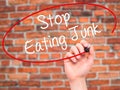 Man Hand writing Stop Eating Junk with black marker on visual sc Royalty Free Stock Photo