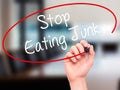 Man Hand writing Stop Eating Junk with black marker on visual sc Royalty Free Stock Photo