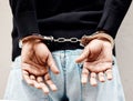 Man, handcuffs and criminal in arrest for crime, justice or theft against the wall of suspect. Closeup of male person Royalty Free Stock Photo