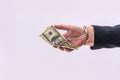 Man in handcuffs holding dollar banknotes isolated, close up Royalty Free Stock Photo