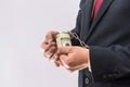 Man in handcuffs holding dollar banknotes isolated, close up Royalty Free Stock Photo
