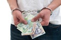 Man in handcuffs is holding money Royalty Free Stock Photo