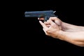 Man with handgun isolated on black